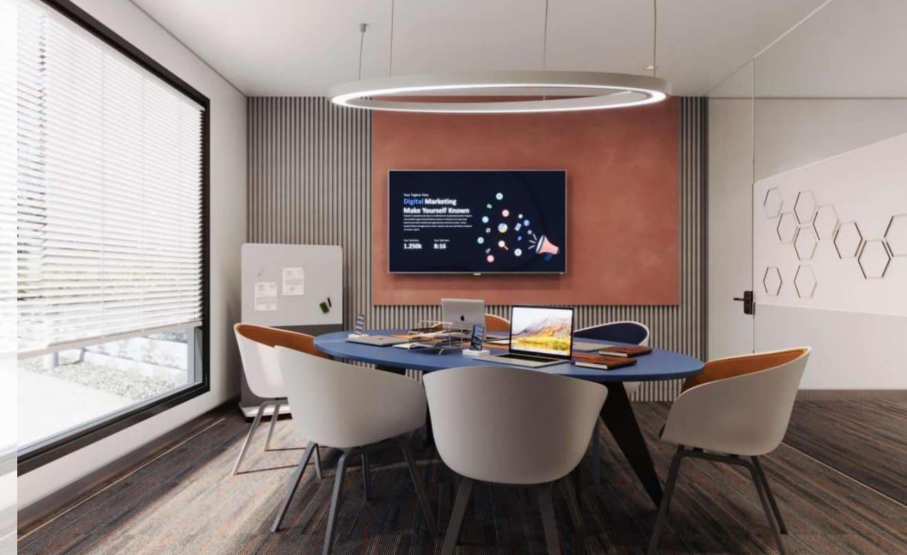 Meeting pod with soft pink accent wall and round table