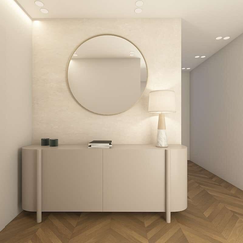 Curved console with round mirror and table lamp