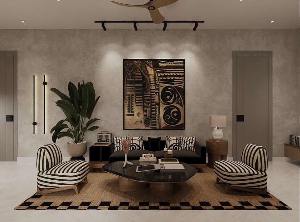 Living room with statement wall art, black sofa and striped armchairs