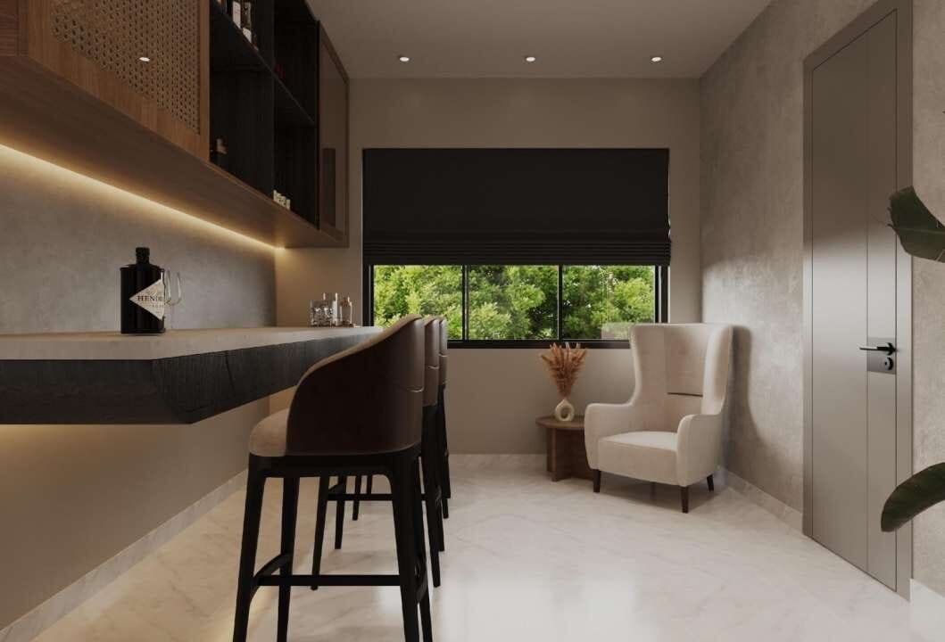 Home bar counter with stools beside a window