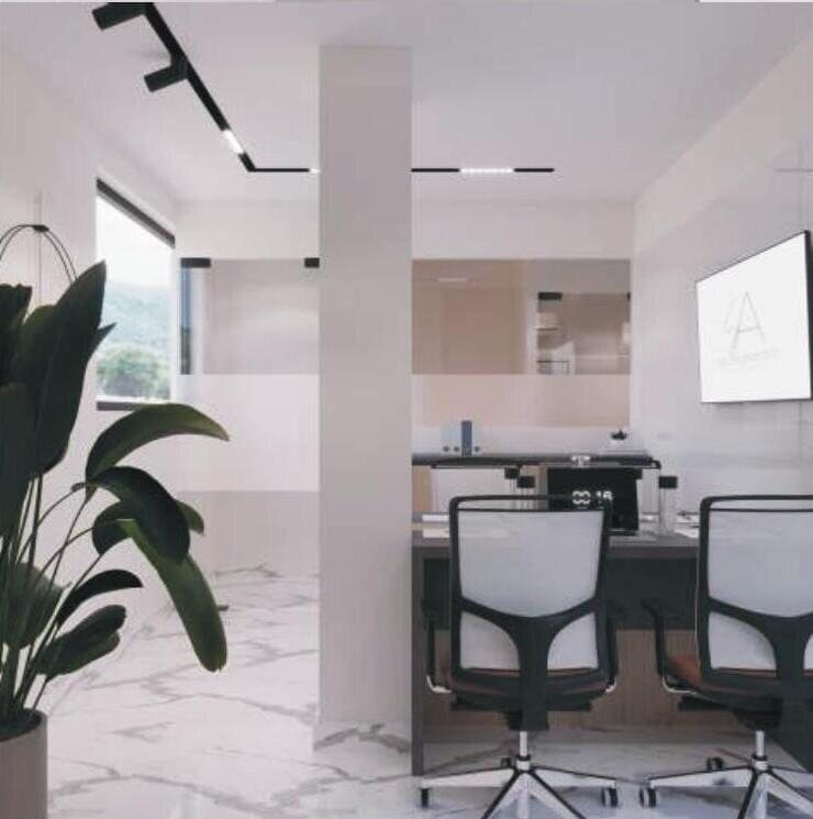 Workstation area beside a window with potted plant